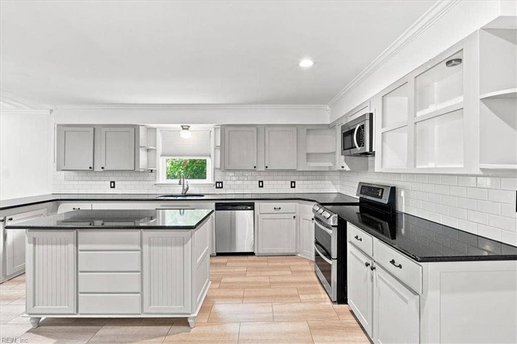 Spacious kitchen with LVP flooring, granite counters.  plenty of counter and cabinet space.  Central island.