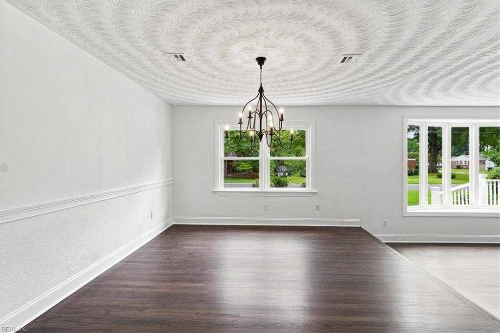 Step up formal dining room with hardwood floors