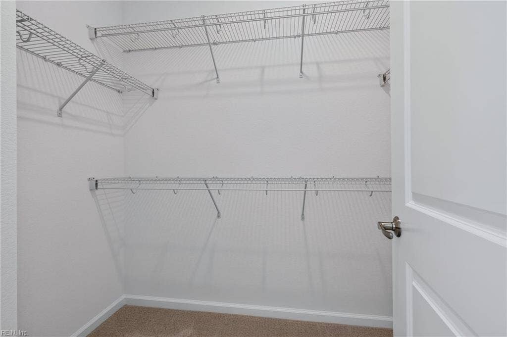 Primary bedroom walk-in closet