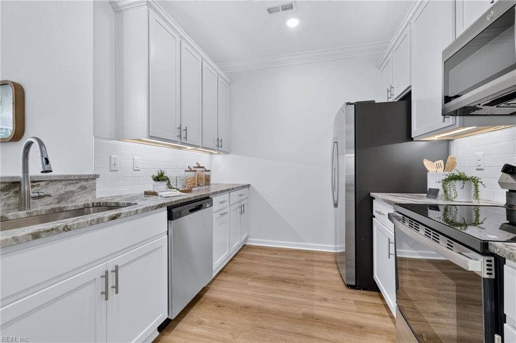 Upgraded kitchen with with soft close cabinets, subway tile backsplash, under cabinet lighting, granite counters and full SS appliance package to include fridge. Plus a pantry and breakfast bar