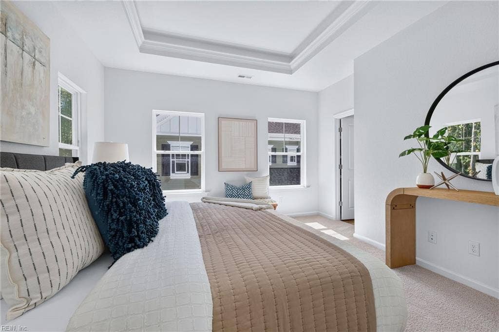 Third view of the primary bedroom flooded with natural light, a decorative ceiling,  walk-in closet and attached primary bathroom