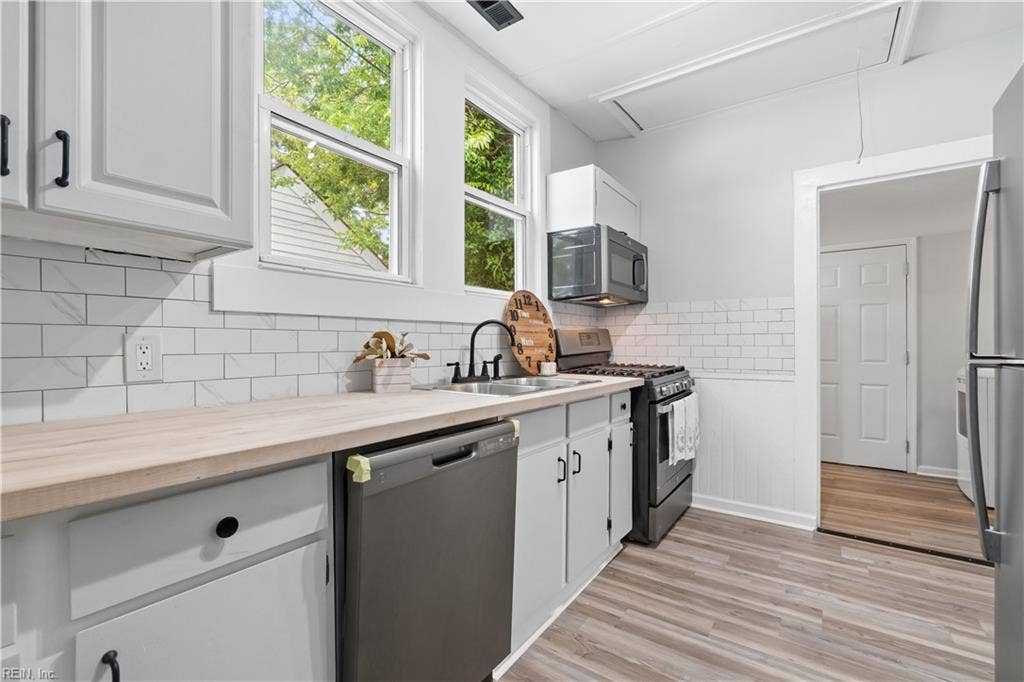 New countertops, tile backsplash, and appliancesSome Photos AI enhanced OR Virtually Staged