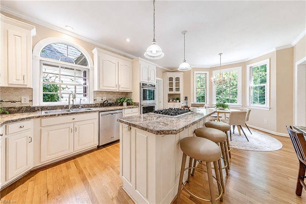 Palladian Window over sink adds more charm to this Bright Kitchen