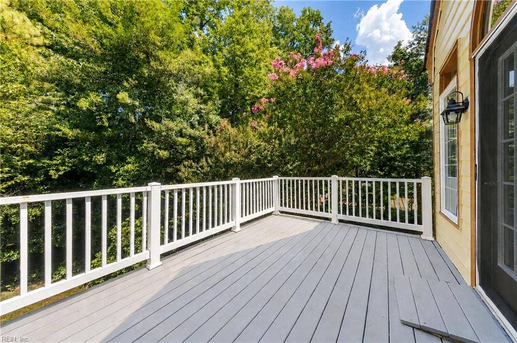 Deck overlooks beautiful backyard