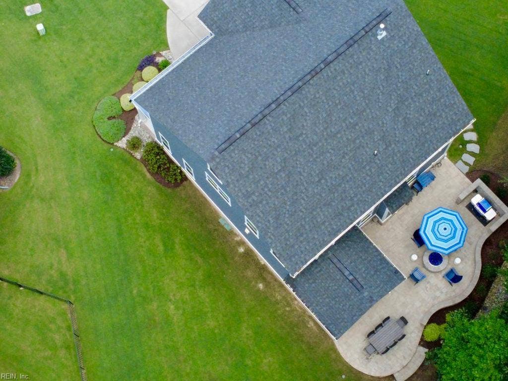 Enhancing the outdoor living experience, the premium built-in fire pit and custom grill station convey entirely with the house. This turnkey backyard setup creates an immediate oasis for evening relaxation and effortless weekend entertaining