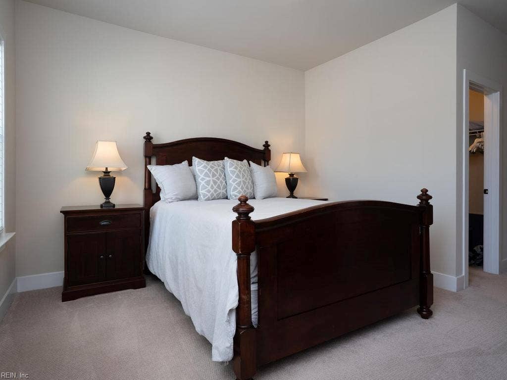 Perfect for guests or family members, the expansive secondary bedroom offers a generous, comfortable footprint that easily accommodates a king-size bed set and additional furniture. Large windows flood the space with natural light,