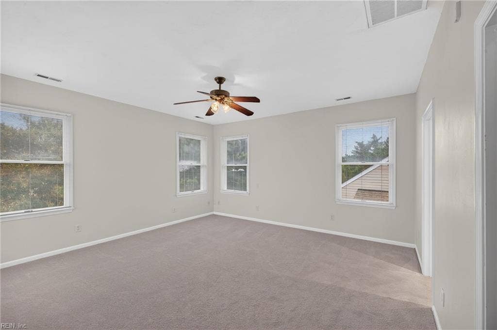 9570 Bay Point Drive, Bay Breeze Point, Norfolk, VA 23518 One more view of this wonderful primary suite with ceiling fan light fixture, new carpet, and tons of windows to let in the natural light.