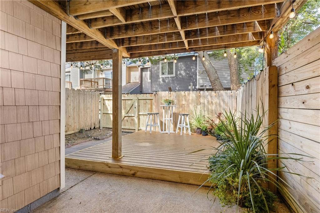 The covered back porch and new privacy fence provide both shade and privacy.