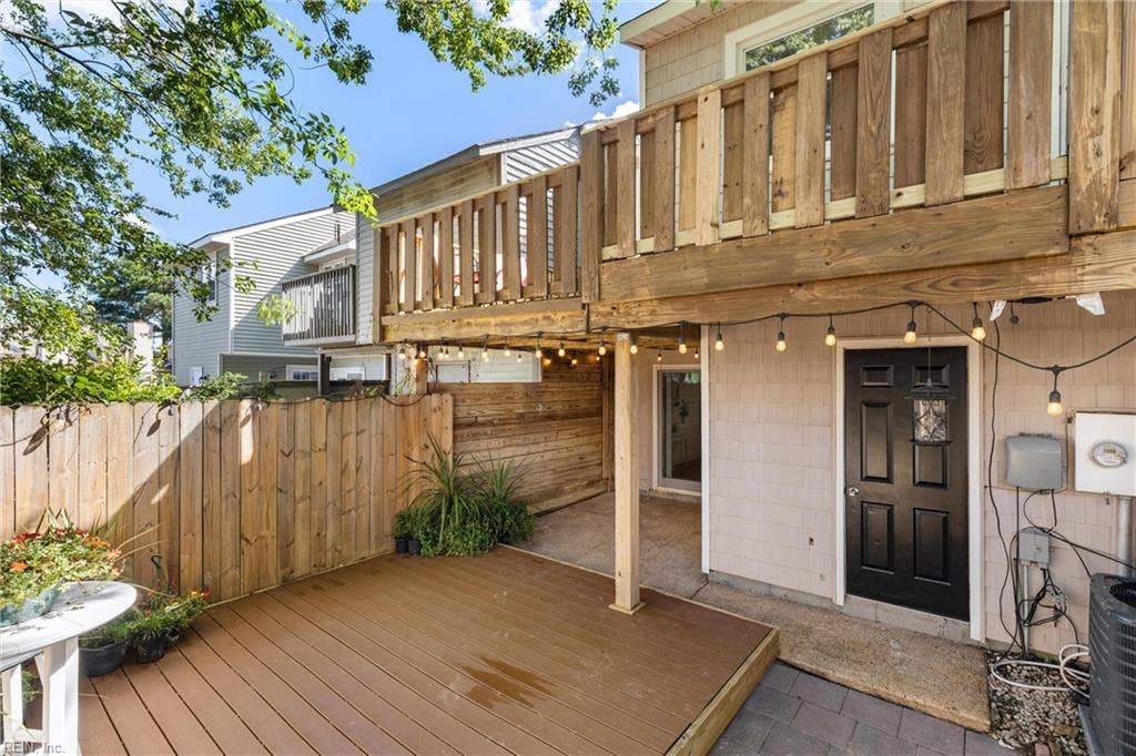The fenced backyard offers a wrap around balcony, composite deck, and covered porch in addition to a little garden area.