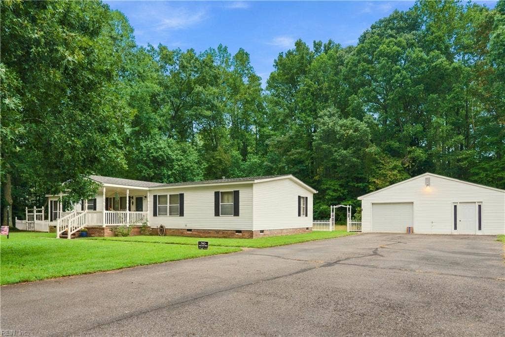 Wide paved driveway - 1 car detached garage with additional storage, home gym or office.