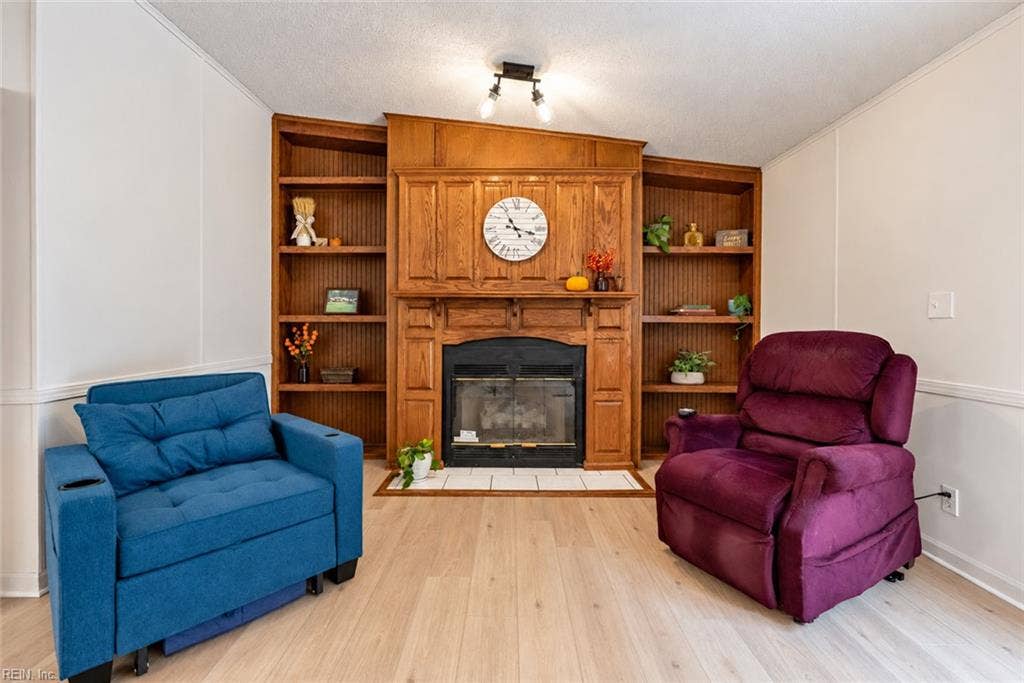 Family room with new floors, updated light fixtures and gas fireplace