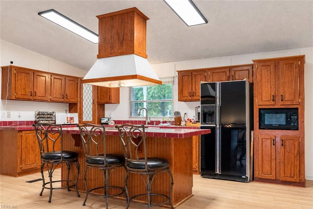 Kitchen island with cook stove and additional seating