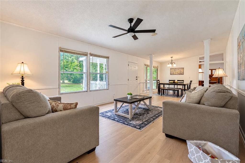 Living room with new floors & new ceiling fan