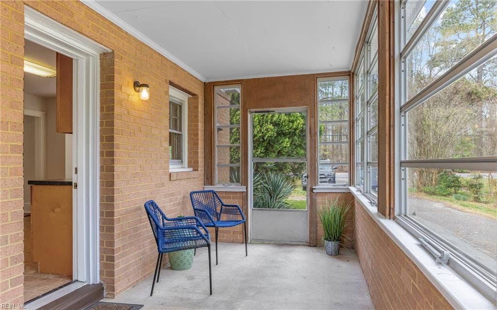 317 George Washington Highway S, Chesapeake, VA 23323 Natural light and multiple windows make this enclosed porch feel open while adding practical bonus space.