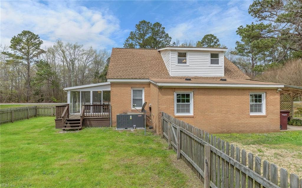 317 George Washington Highway S, Chesapeake, VA 23323 The fenced yard sits just off the enclosed porch, creating a practical connection between indoor and outdoor spaces.