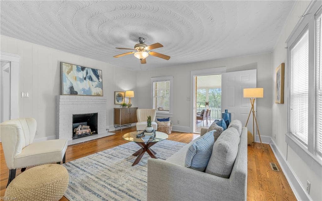 317 George Washington Highway S, Chesapeake, VA 23323 The main living room blends hardwood floors, a fireplace and direct access to the enclosed porch.