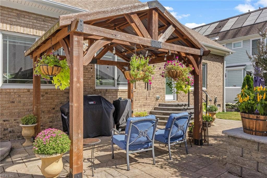 2309 Valle Rio Way, Virginia Beach, VA 23456 A timber-framed covered seating area offers shade and a comfortable place to relax beside the pool.
