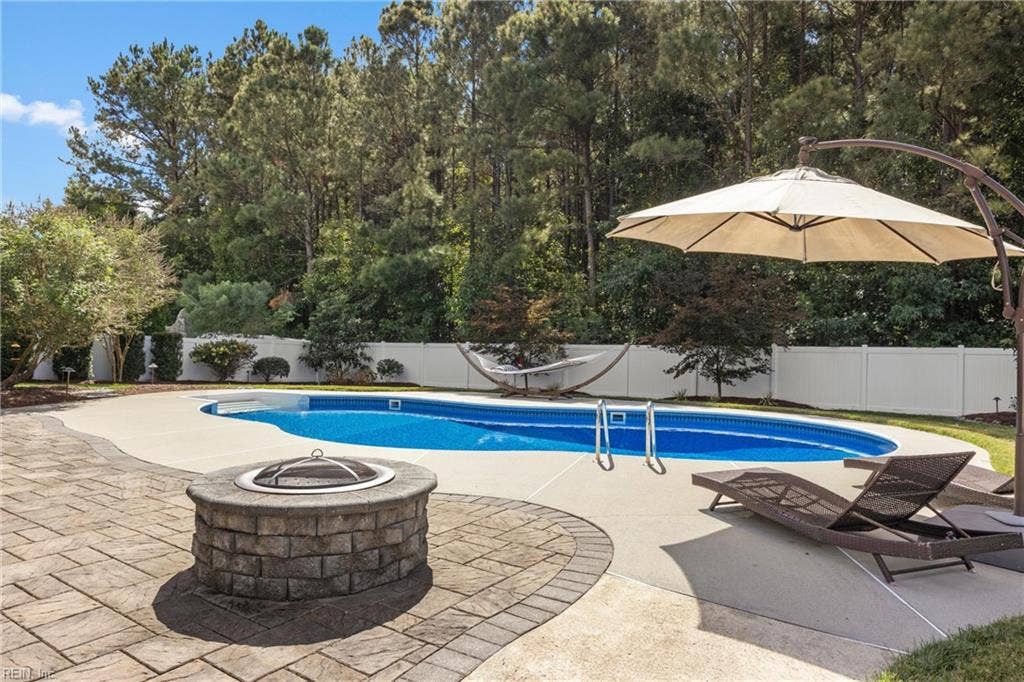 2309 Valle Rio Way, Virginia Beach, VA 23456 The saltwater pool enjoys a wooded backdrop, with no neighboring home directly behind the property.