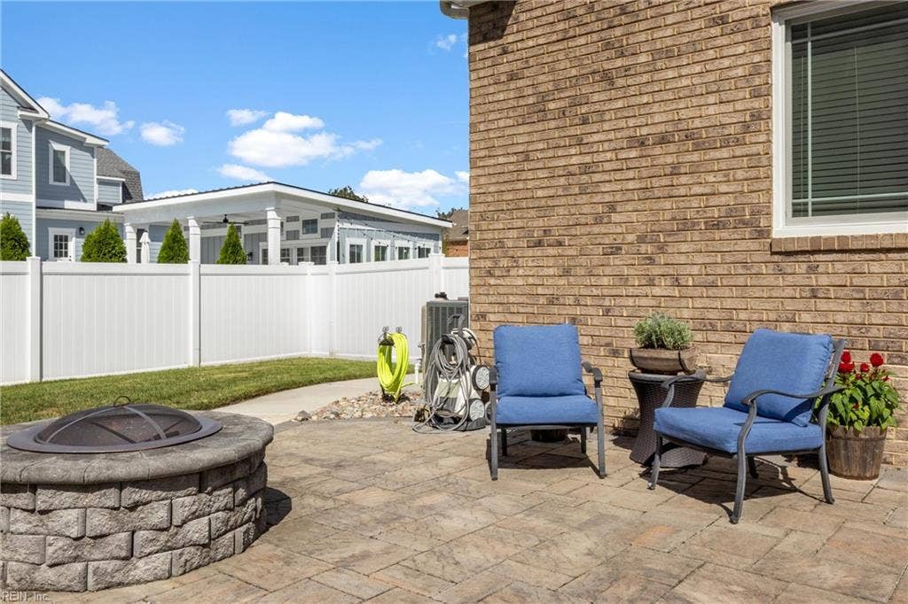 2309 Valle Rio Way, Virginia Beach, VA 23456 A built-in fire-pit area and stamped-concrete patio create a gathering place beyond the pool.