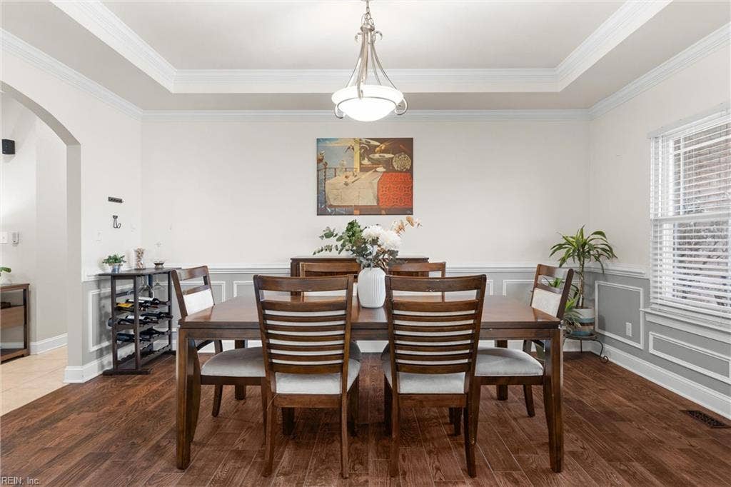 2309 Valle Rio Way, Virginia Beach, VA 23456 A tray ceiling, decorative wall trim, and wood flooring give the dedicated dining room an elegant finish.