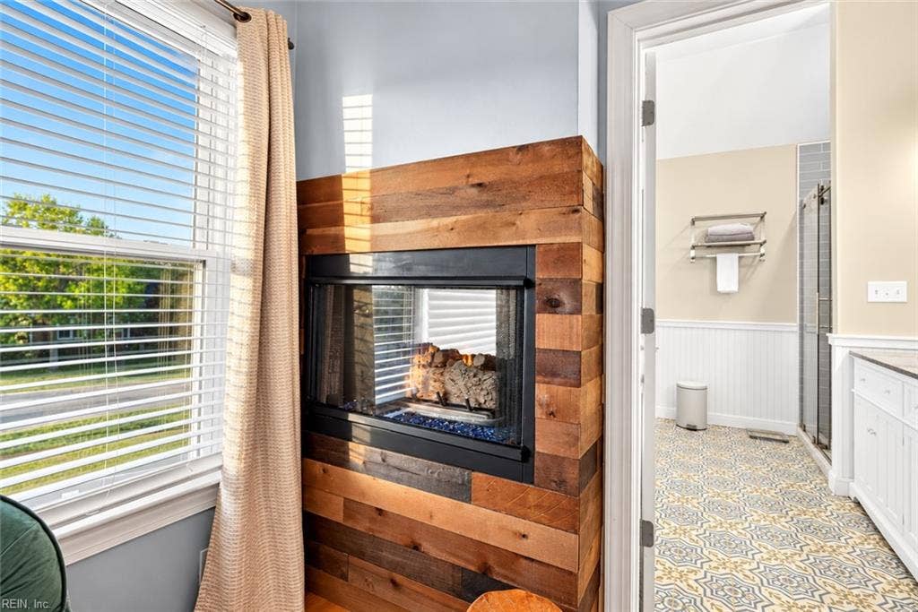 Double-sided fireplace creates a unique connection between the primary suite and bath