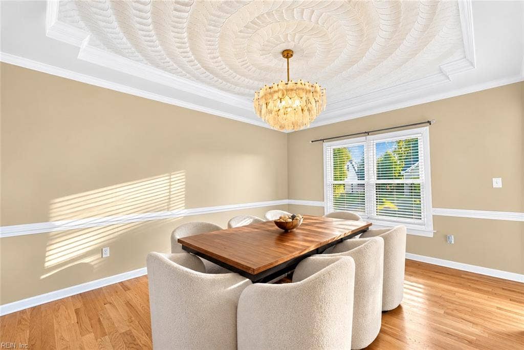 Formal dining room with architectural details and elegant chandelier