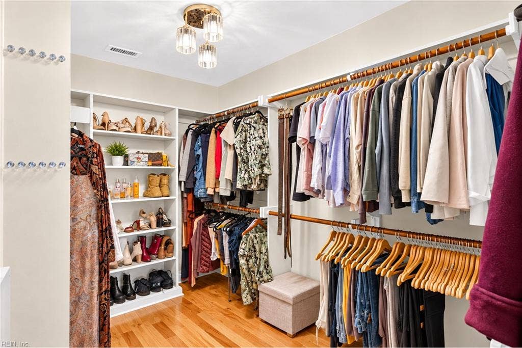 Expansive walk-in closet with custom shelving and hanging space