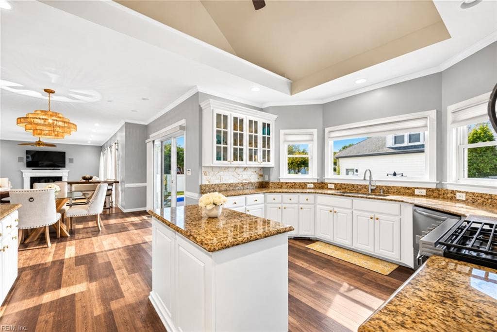 Open kitchen layout with beautiful hardwood floors and natural light