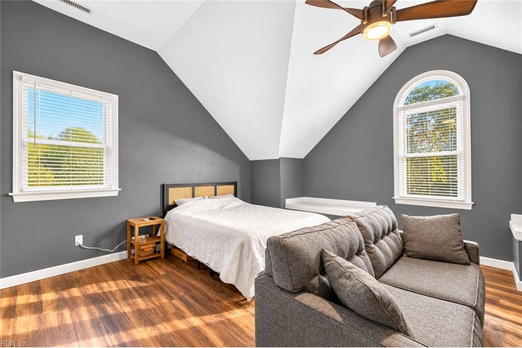 Spacious secondary bedroom with dramatic vaulted ceiling and dedicated bathroom.
