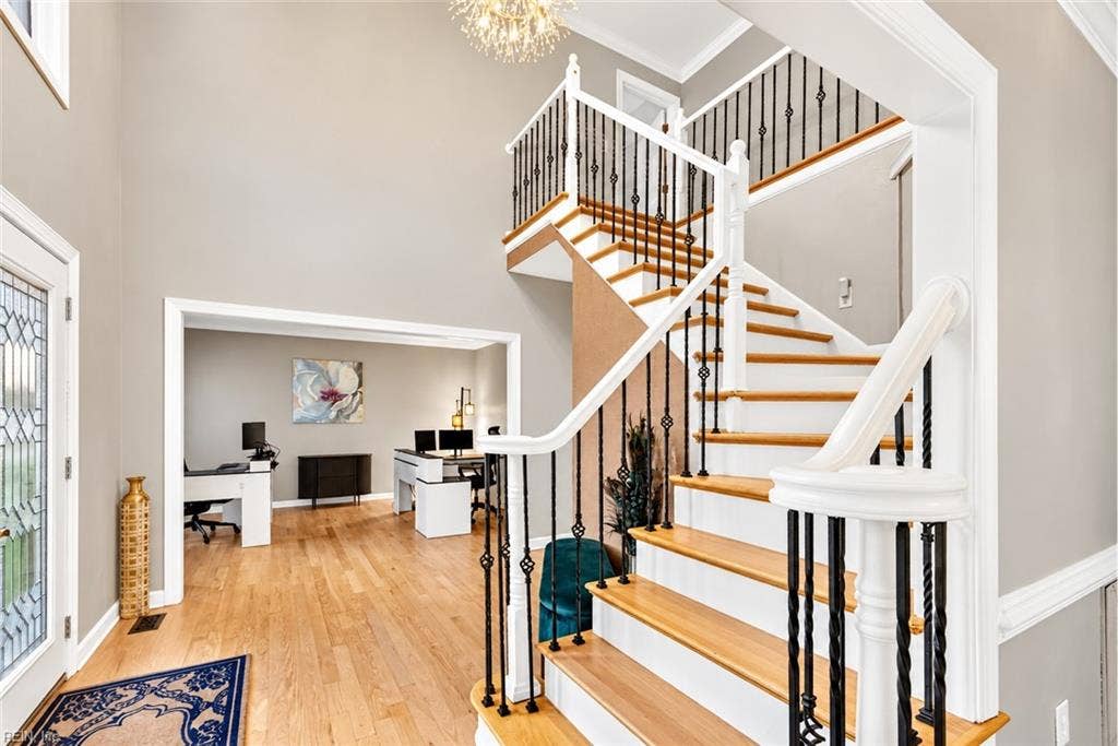 Grand two-story entry with beautiful hardwood staircase