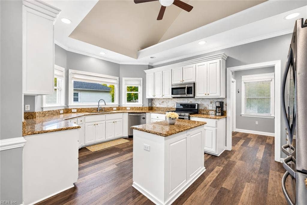 Updated kitchen with center island and stainless steel appliances
