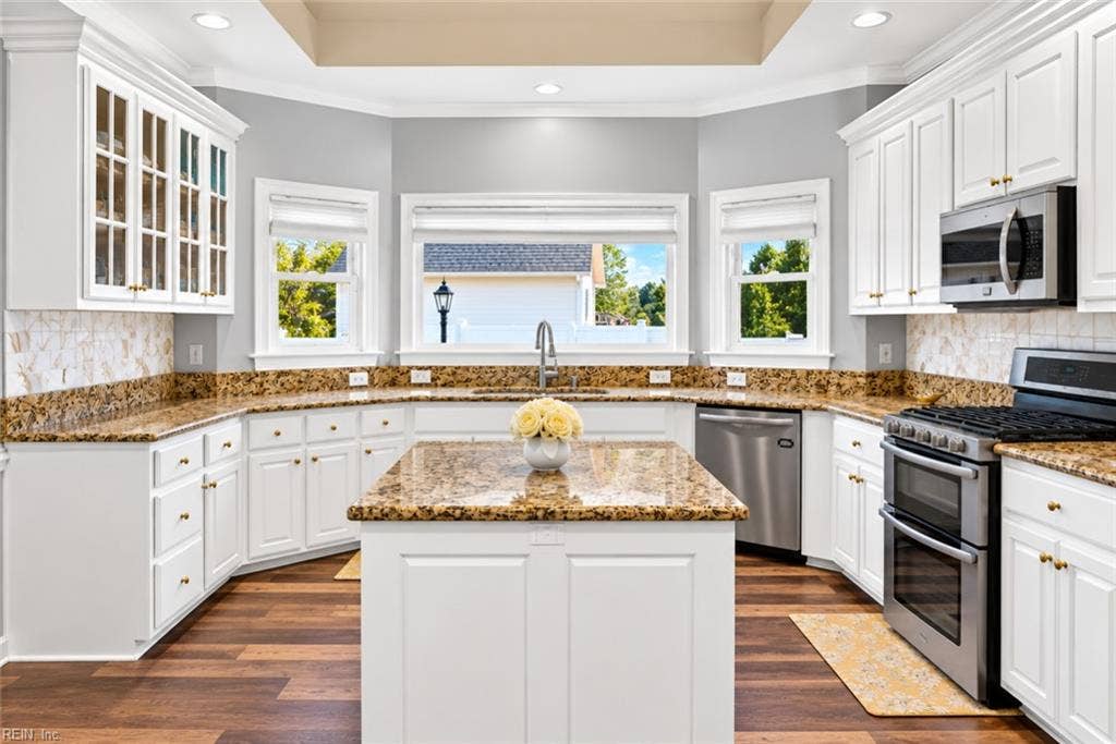 Bright, beautifully updated kitchen with abundant cabinetry and prep space