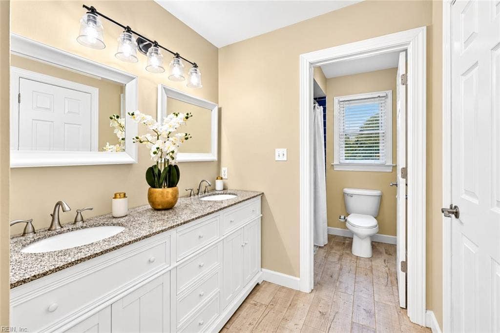 Bright double-vanity bath with separate shower area.