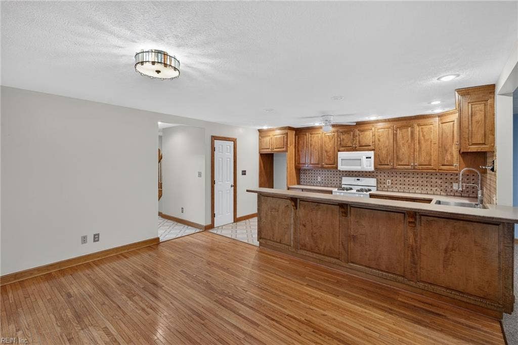 The laundry room is located behind the door off the kitchen.