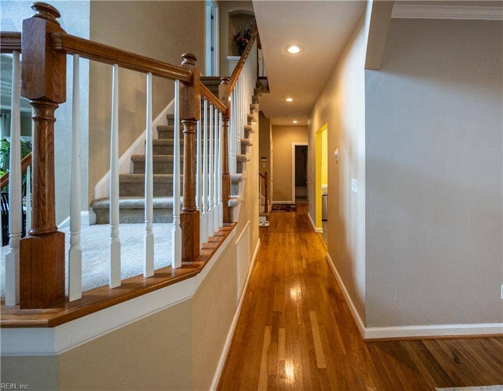 This back hallway leads to the garage, downstairs full bath and large downstairs bedroom #6