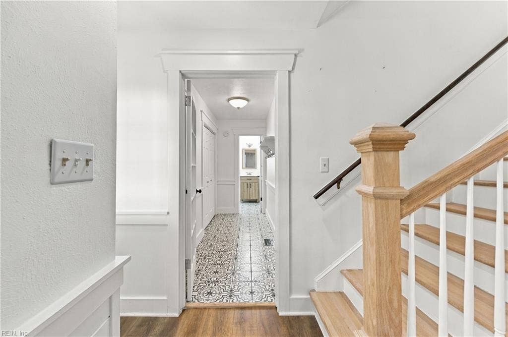 Foyer hallway leading to the downstairs laundry and full bathroom downstairs