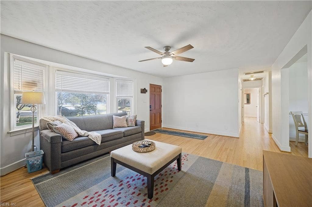 Large Family Room with hardwood floors, ceiling fan/light and wood-burning fireplace
