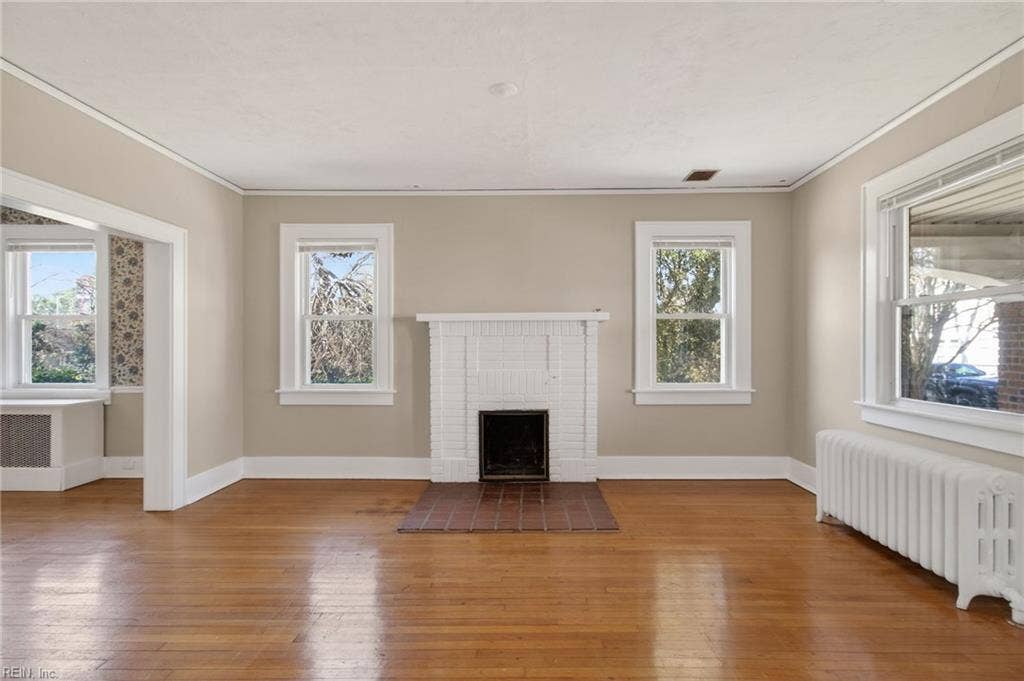 Plenty of natural light; original wood fireplace, and wood floors