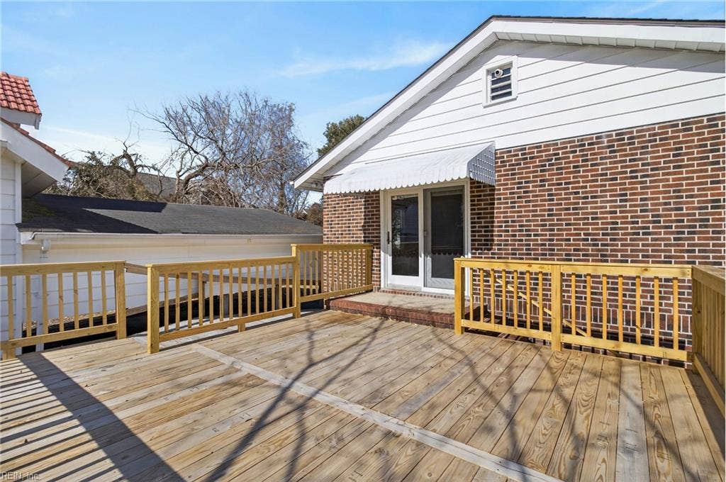 Large wood deck raised to height of first floor access