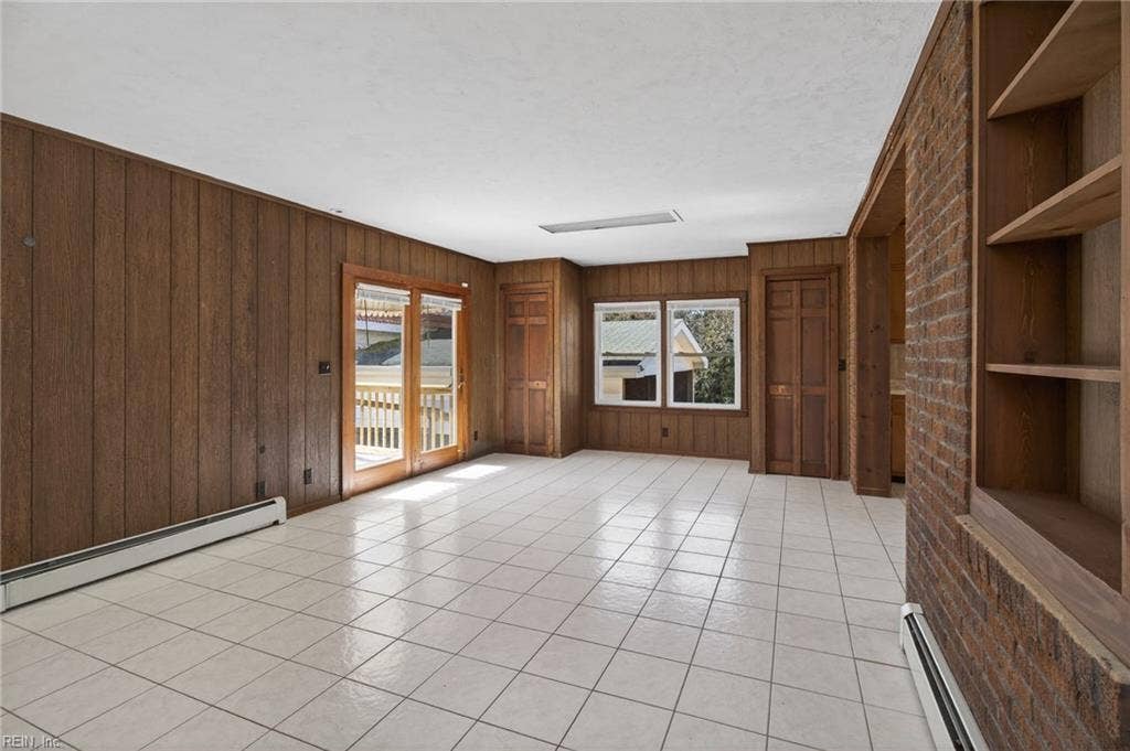 Large family room naturally flows out to wood deck and large yard