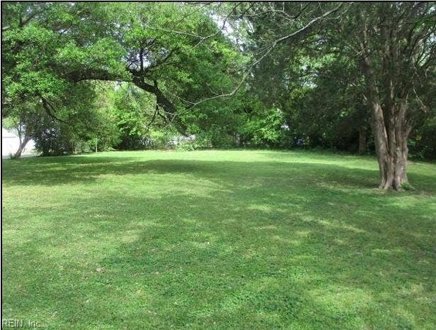 View from back of property looking toward Cornick Rd and front corner of lot with partial neighboring fence line