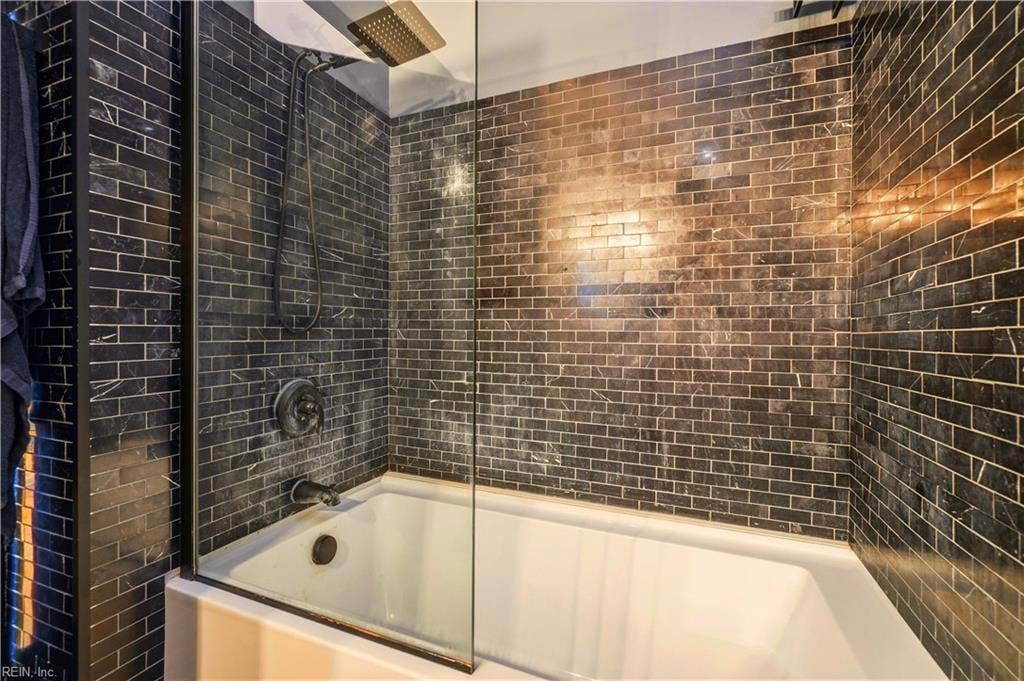 Spectacular tile work in Bath and sleek rectangular tub.