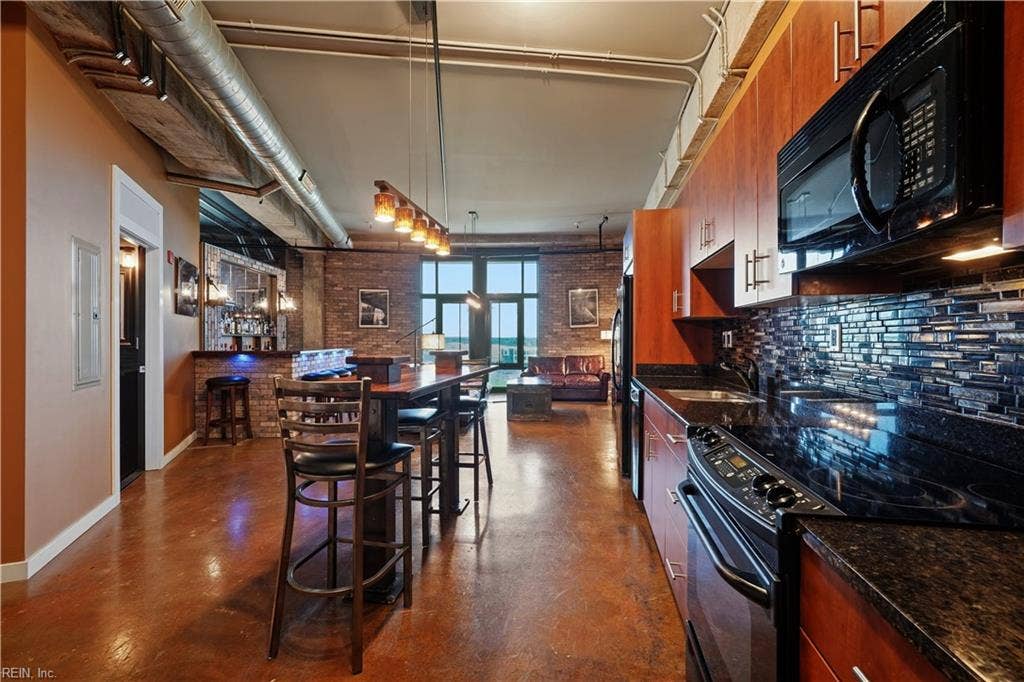 Kitchen with Black Walnut and Steel Center Island for work space or informal meals, glass tiled backsplash