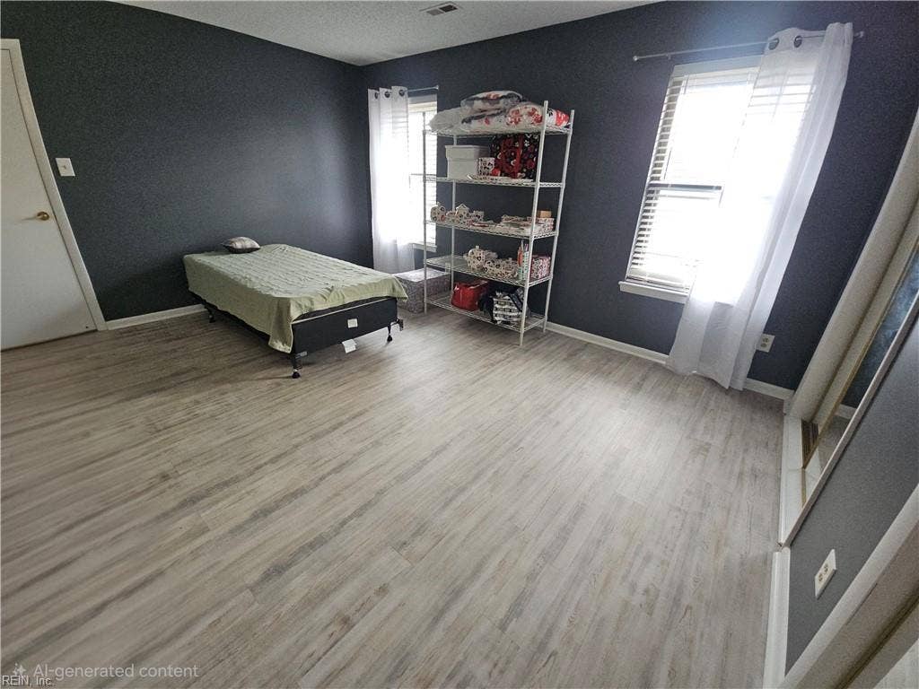 First bedroom is spacious and bright with beautiful laminate floors