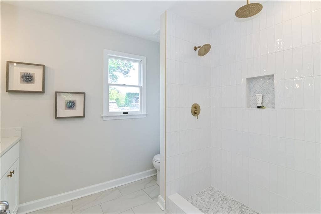 New primary marble bath with designer fixtures and finishes.