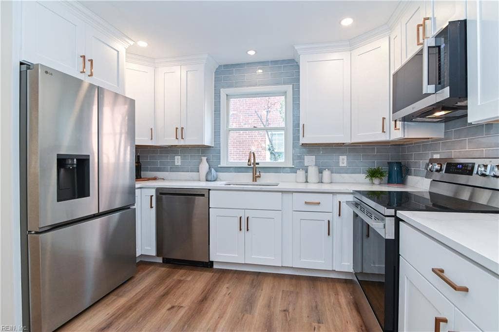 New designer kitchen with custom  designer backsplash, and new stainless steel appliances.
