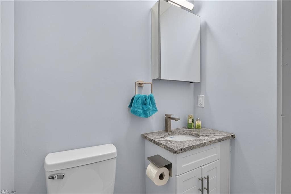 1008 80th Street, Newport News, VA 23605 Hald bath with new vanity and granite countertop.