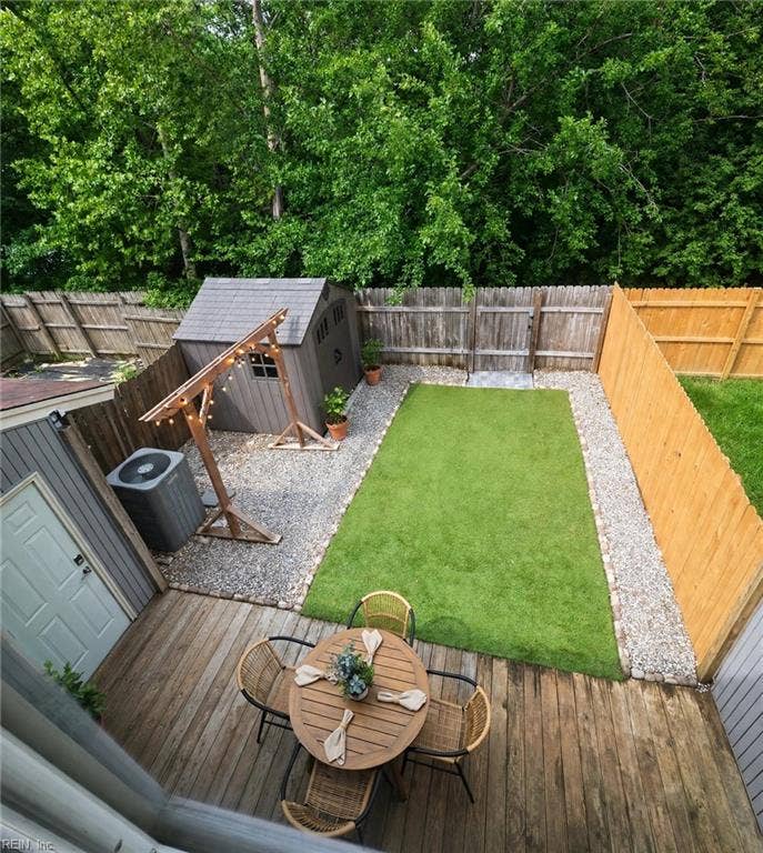 Storage shed and gated rear fence backing to trees.