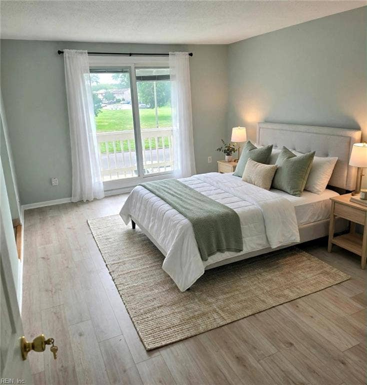 Primary suite with private balcony overlooking the green. Virtually staged.