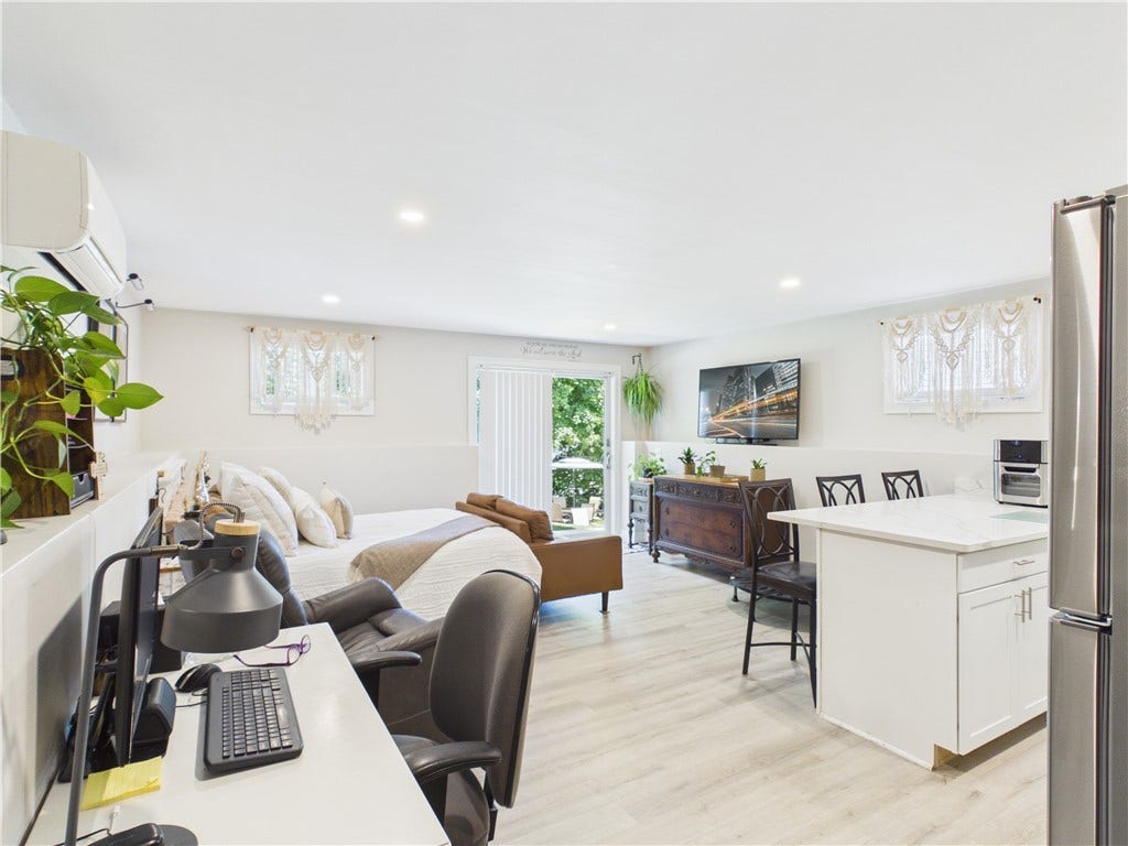 36 Bellevue Avenue, North Smithfield, RI 02896 Spacious lower-level living area with exterior access, providing room for lounging, dining, working, or creating a comfortable guest suite.